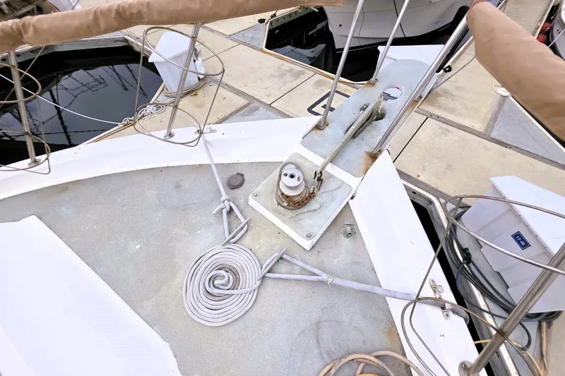 Slide: The Image of 1984 Californian 43 Motoryacht bow with coiled rope and anchor mechanism at dock. - 23