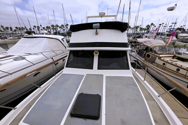 Slide: The Image of 1984 Californian 43 Motoryacht docked in marina, surrounded by other boats. - 25