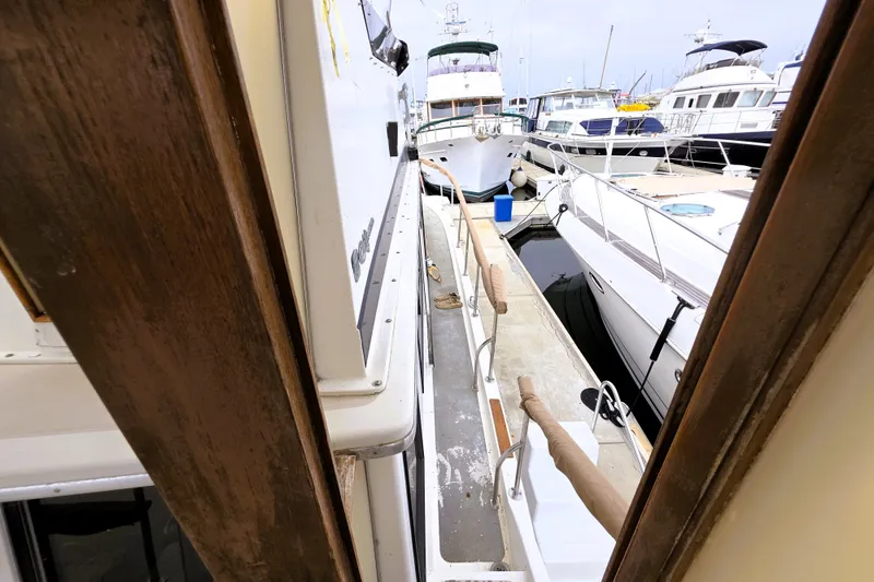 Slide: The Image of 1984 Californian 43 Motoryacht docked among other boats in a marina. - 22
