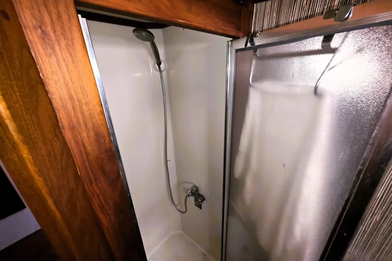 Slide: The Image of Shower area in 1984 Californian 43 Motoryacht with wooden trim and sliding door. - 17