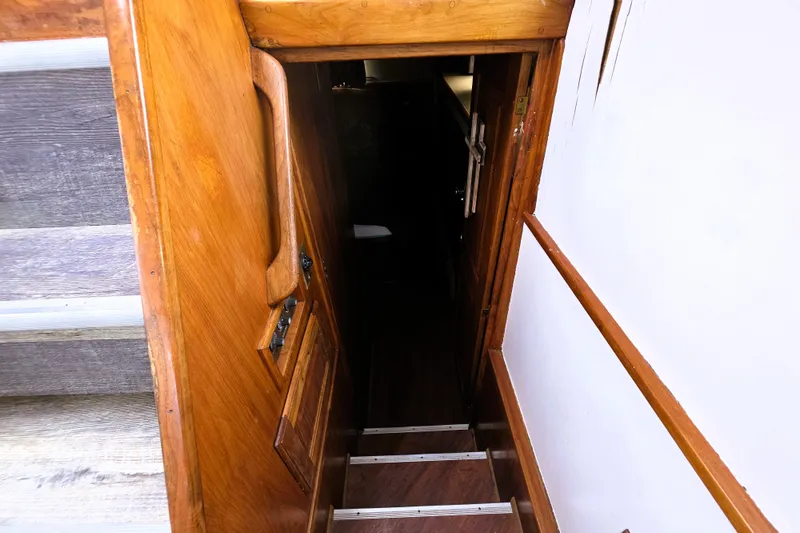 Slide: The Image of Wooden staircase leading to cabin interior of 1984 Californian 43 Motoryacht. - 14