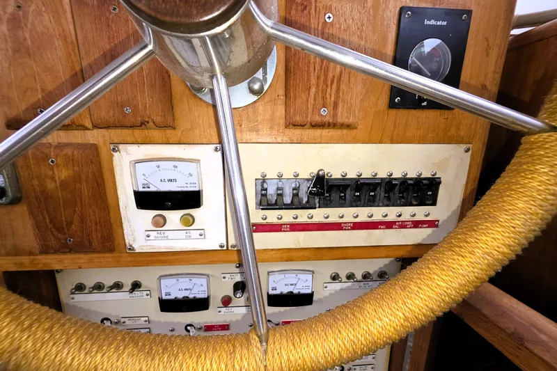 Slide: The Image of 1984 Californian 43 Motoryacht helm with gauges and controls, featuring a wooden dashboard. - 21