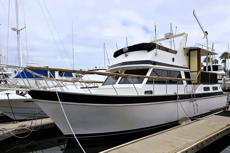 The Image of 1984 Californian 43 Motoryacht docked at marina under cloudy sky. - 0