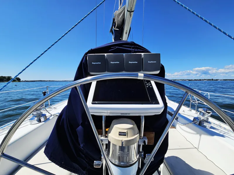 Slide: The Image of The image shows the cockpit of a 1999 Catalina 42 MkII with a steering wheel and navigation equipment. - 16