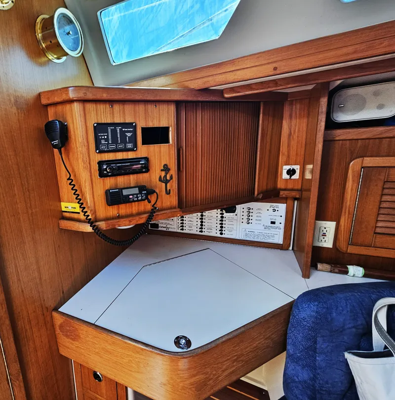 Slide: The Image of Navigation station of the 1999 Catalina 42 MkII with wood paneling and communication equipment. - 35
