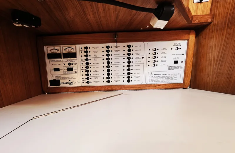 Slide: The Image of The image shows the electrical panel of a 1999 Catalina 42 MkII with various switches and gauges. - 36