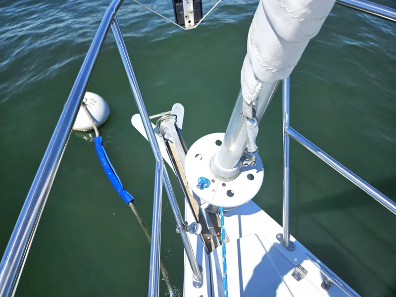 Slide: The Image of Close-up of a sailboat's bow with anchor and buoy in the water. - 9