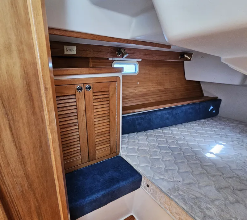 Slide: The Image of Interior of a 1999 Catalina 42 MkII with wooden cabinetry and blue upholstery. - 41