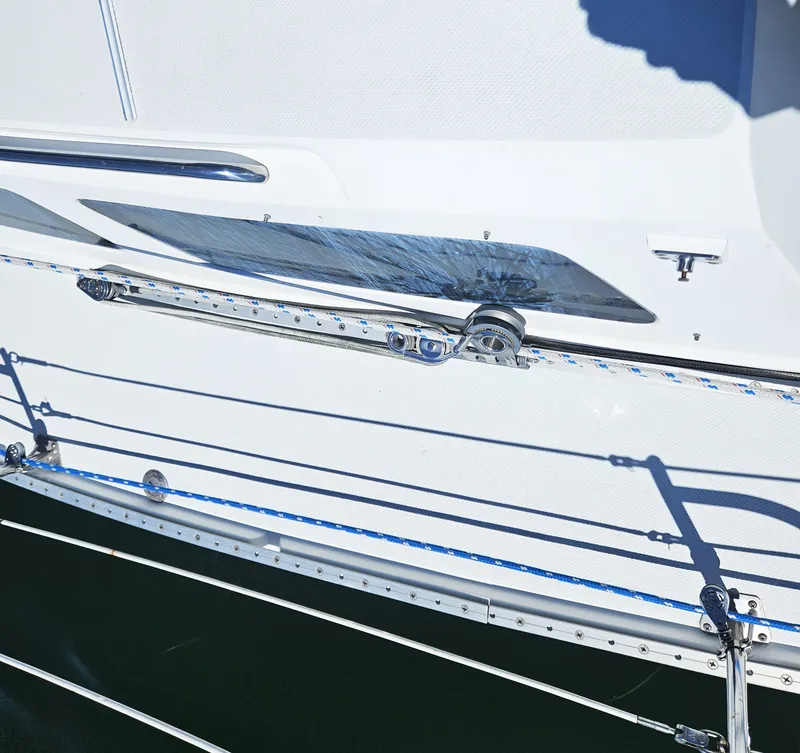 Slide: The Image of Close-up of a white sailboat with blue and white ropes and metal fittings. - 8