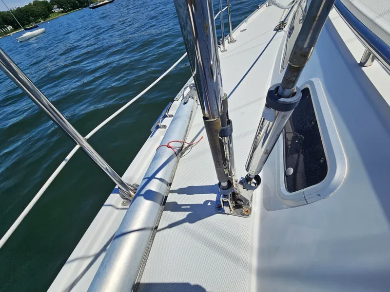 Slide: The Image of Close-up of the deck on a 1999 Catalina 42 MkII with shiny metal railings. - 12