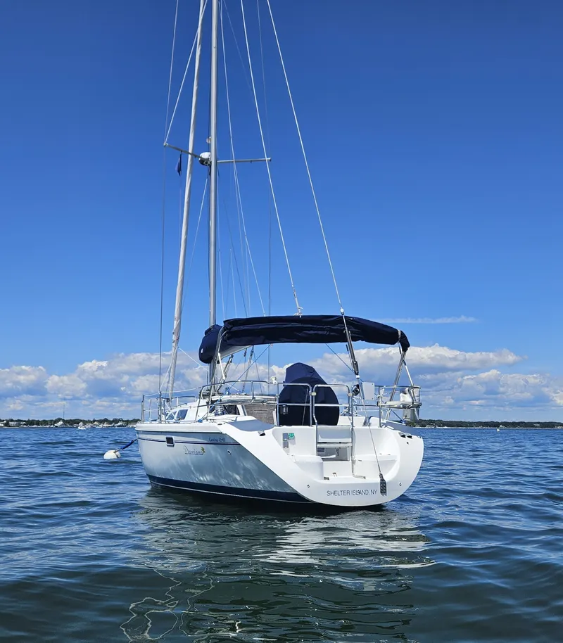 Slide: The Image of A white sailboat calmly floating on the water, with a blue sky in the background. - 5