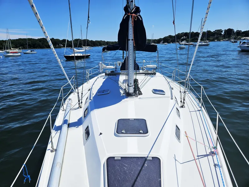 Slide: The Image of The deck of a 1999 Catalina 42 MkII on calm water with several sailboats in the background. - 11