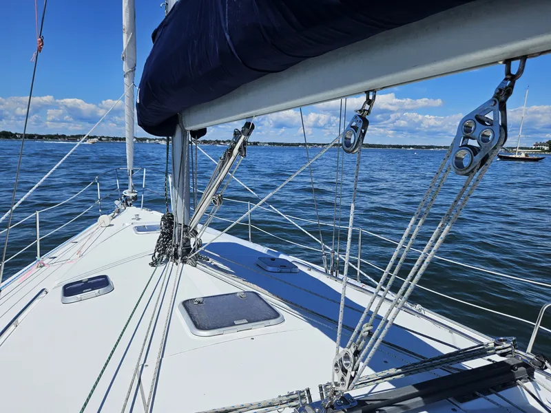 Slide: The Image of The deck of a 1999 Catalina 42 MkII with sail and rigging on calm water. - 7