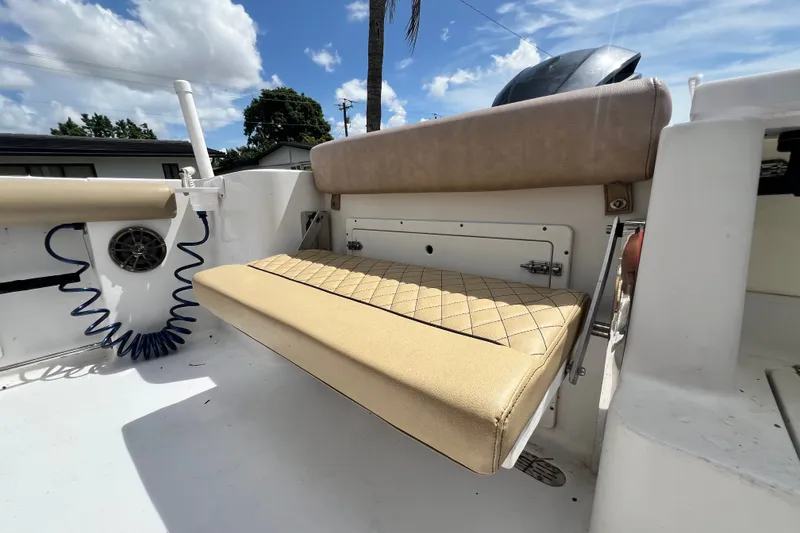 Slide: The Image of 2016 Sportsman Heritage 231 Center Console boat with beige cushioned seating and storage compartment. - 49