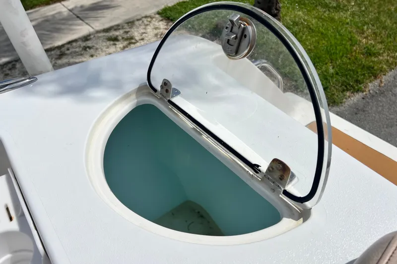 Slide: The Image of Open hatch on 2016 Sportsman Heritage 231 Center Console boat, showcasing storage compartment. - 54