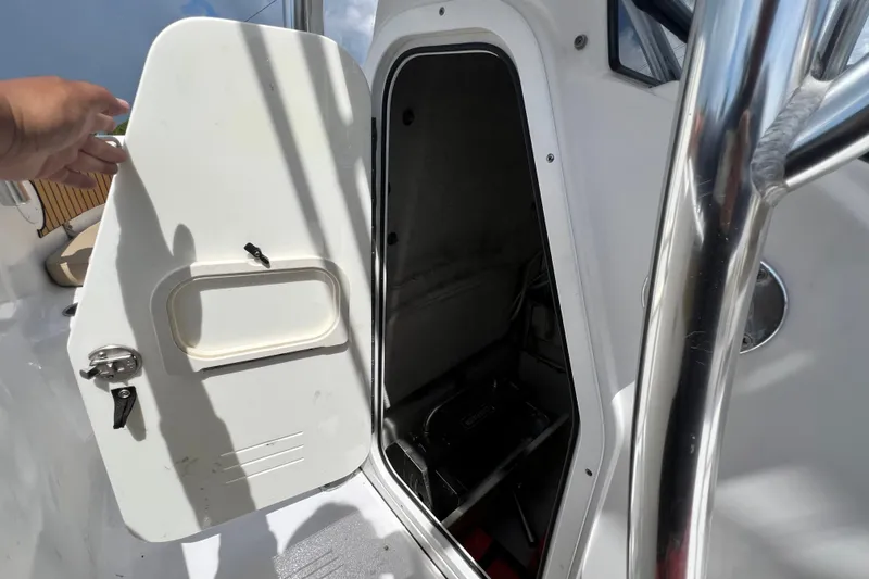 Slide: The Image of 2016 Sportsman Heritage 231 Center Console boat storage compartment open. - 29