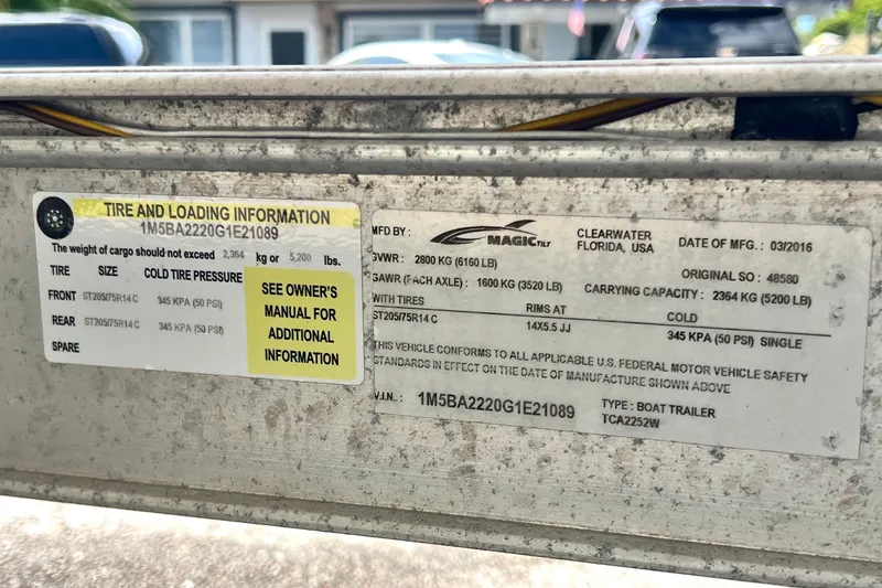 Slide: The Image of Tire and loading information label on a 2016 Sportsman Heritage 231 Center Console boat trailer. - 58