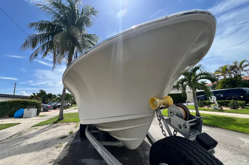 Slide: The Image of 2016 Sportsman Heritage 231 Center Console boat on trailer, sunny day, palm trees. - 11