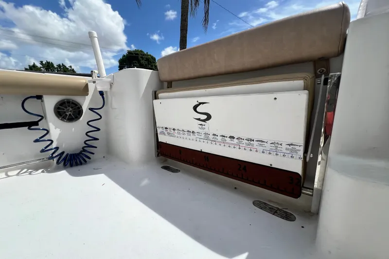 Slide: The Image of 2016 Sportsman Heritage 231 Center Console interior with fish ruler and coiled hose. - 48