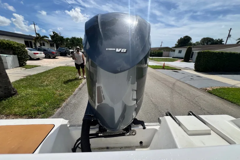 Slide: The Image of 2016 Sportsman Heritage 231 Center Console with Yamaha V8 engine on a residential street. - 55