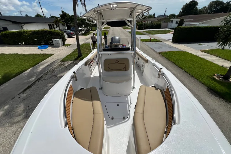 Slide: The Image of 2016 Sportsman Heritage 231 Center Console boat on residential street, showcasing interior seating. - 38