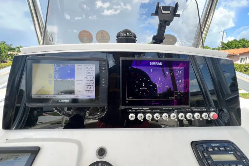 Slide: The Image of 2016 Sportsman Heritage 231 Center Console dashboard with Garmin and Simrad displays. - 20