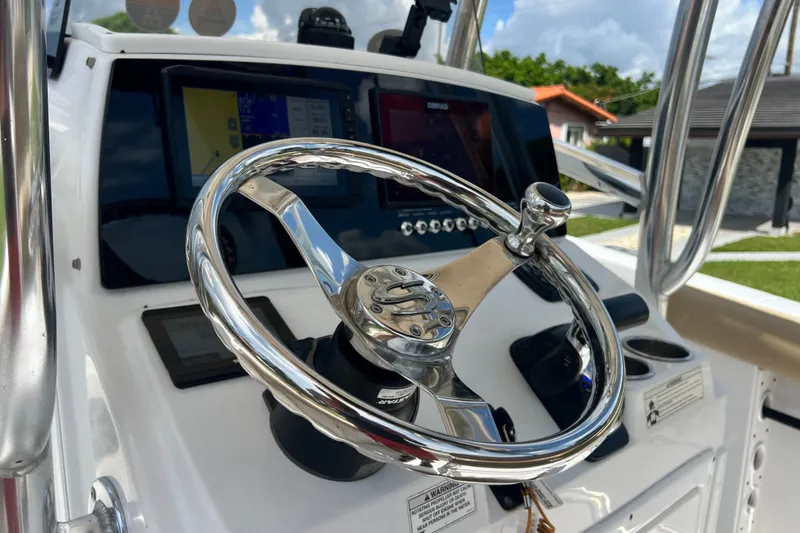 Slide: The Image of Steering wheel of 2016 Sportsman Heritage 231 Center Console boat, featuring modern controls. - 21