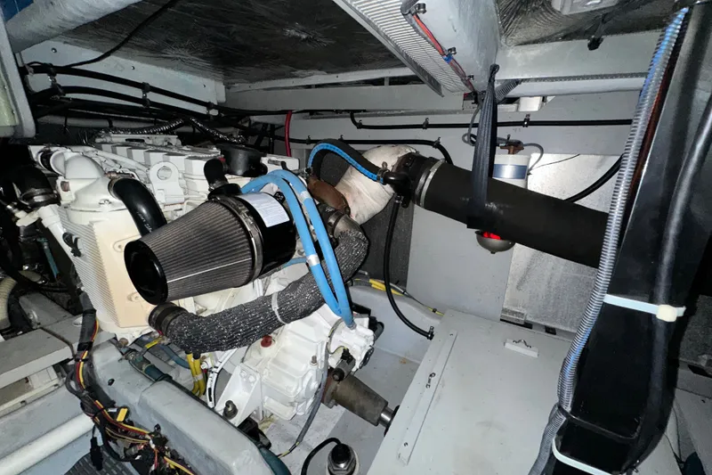 Slide: The Image of Engine room of a 2007 Meridian 411 Sedan yacht, showcasing mechanical components and wiring. - 132