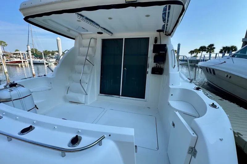 Slide: The Image of 2007 Meridian 411 Sedan yacht docked at marina, featuring spacious deck and sleek design. - 26