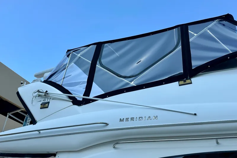 Slide: The Image of 2007 Meridian 411 Sedan yacht with clear canopy against blue sky. - 25