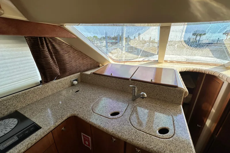 Slide: The Image of Interior of 2007 Meridian 411 Sedan yacht kitchen with granite countertops and modern fixtures. - 117