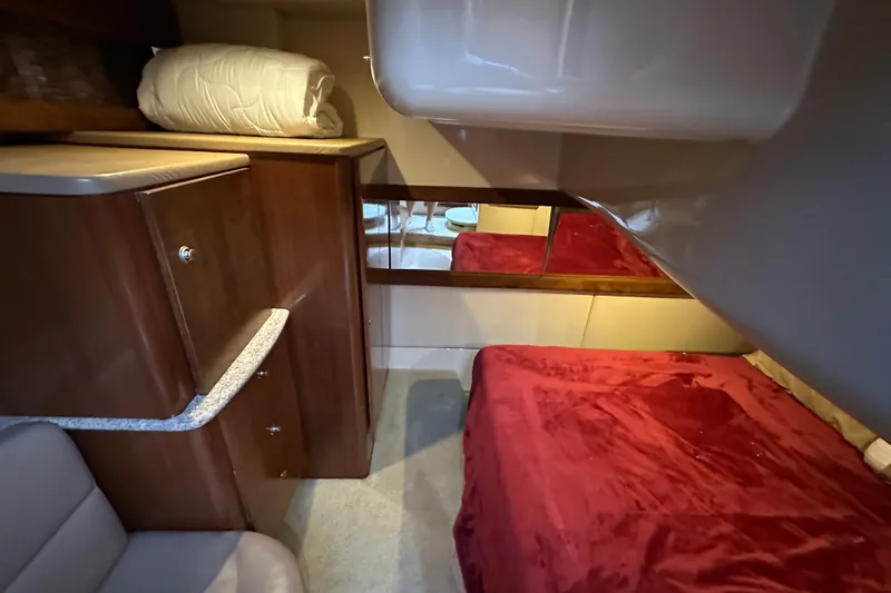 Slide: The Image of Luxurious cabin interior of 2007 Meridian 411 Sedan with red bedding and wooden cabinetry. - 74