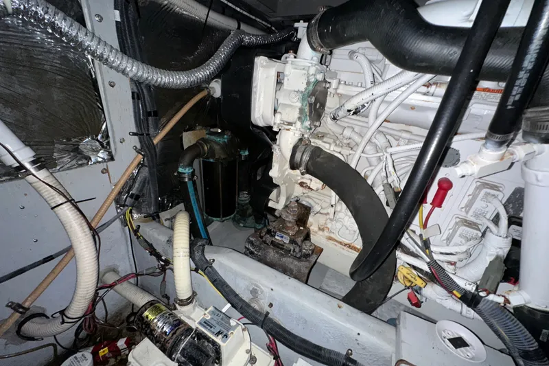 Slide: The Image of Engine room of a 2007 Meridian 411 Sedan yacht, showcasing mechanical components and wiring. - 137
