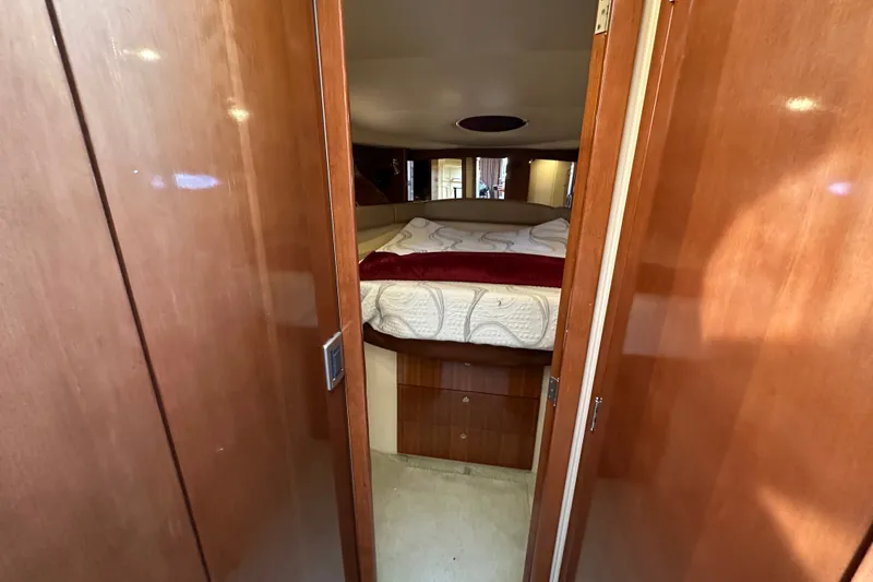 Slide: The Image of Interior cabin view of a 2007 Meridian 411 Sedan yacht, featuring a cozy bed. - 94