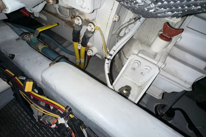 Slide: The Image of Engine compartment of a 2007 Meridian 411 Sedan with visible wiring and components. - 143