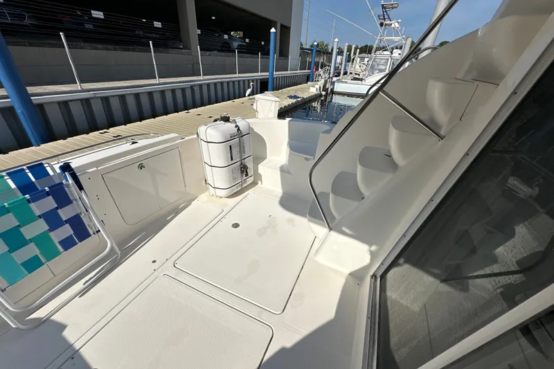 Slide: The Image of 2007 Meridian 411 Sedan yacht deck with seating and stairs at marina. - 68