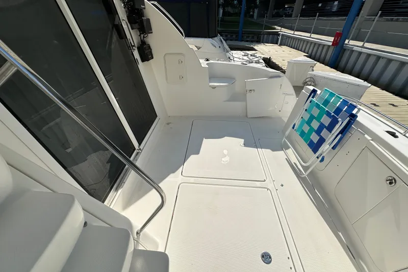 Slide: The Image of 2007 Meridian 411 Sedan yacht deck with seating and railing, docked at marina. - 65