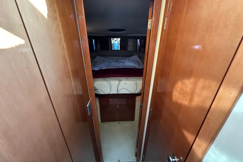 Slide: The Image of Interior view of 2007 Meridian 411 Sedan bedroom with wooden doors and cozy bed. - 82