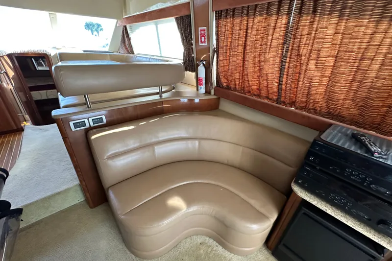 Slide: The Image of Luxurious interior of a 2007 Meridian 411 Sedan yacht with leather seating and wood accents. - 126