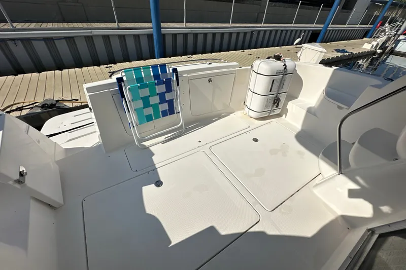 Slide: The Image of 2007 Meridian 411 Sedan boat deck with chair and life preserver. - 66