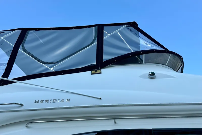 Slide: The Image of 2007 Meridian 411 Sedan yacht with clear enclosure against blue sky. - 22