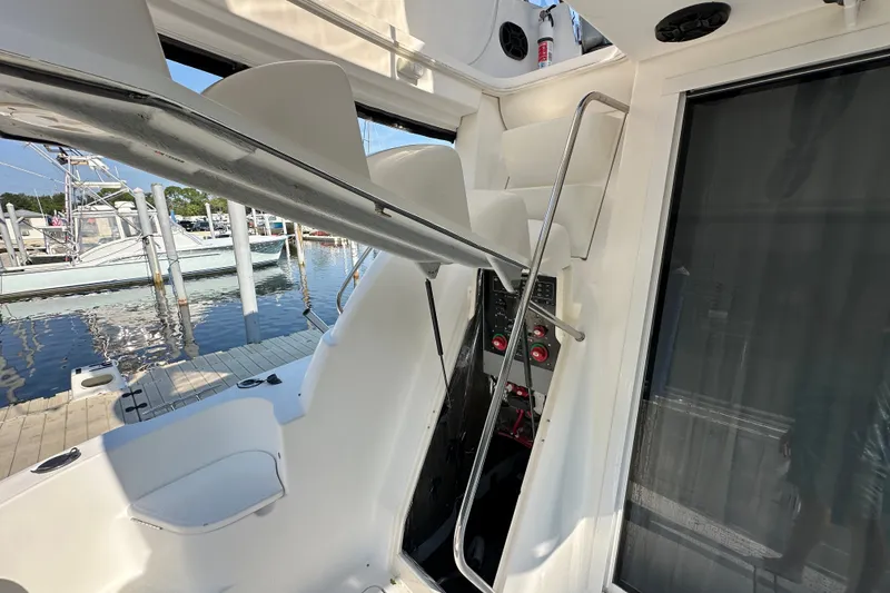 Slide: The Image of Interior view of a 2007 Meridian 411 Sedan yacht, showcasing seating and control panel. - 114