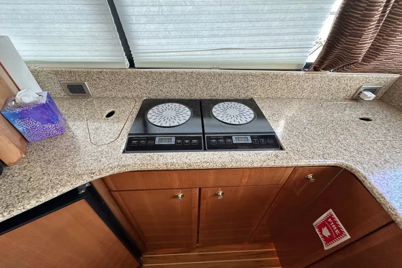 Slide: The Image of 2007 Meridian 411 Sedan kitchen with induction cooktop and granite countertop. - 95