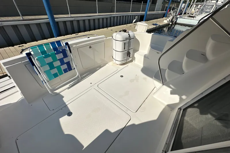 Slide: The Image of 2007 Meridian 411 Sedan yacht deck with seating and storage, docked at marina. - 67