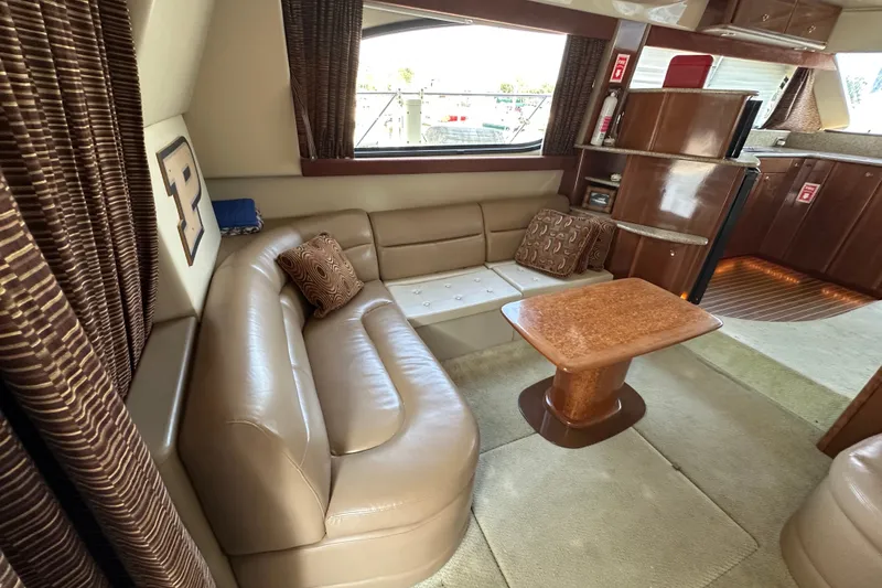 Slide: The Image of Luxurious interior of a 2007 Meridian 411 Sedan yacht with leather seating and wooden table. - 46