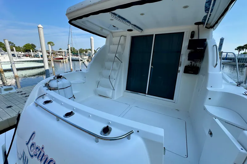 Slide: The Image of 2007 Meridian 411 Sedan yacht docked at marina, featuring spacious deck and sliding doors. - 27