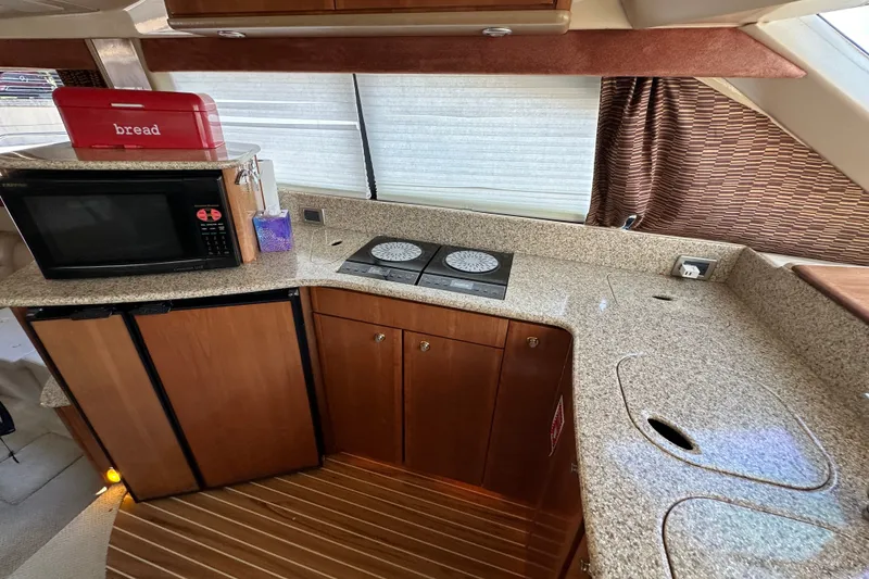 Slide: The Image of Luxurious 2007 Meridian 411 Sedan yacht kitchen with granite countertops and modern appliances. - 92