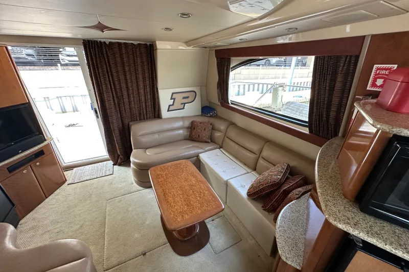 Slide: The Image of Interior of a 2007 Meridian 411 Sedan yacht with beige seating and wooden accents. - 51