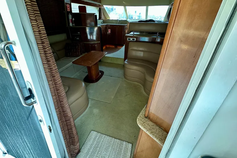 Slide: The Image of Interior of a 2007 Meridian 411 Sedan yacht with leather seating and wooden accents. - 40