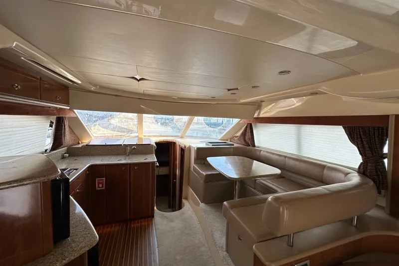 Slide: The Image of Luxurious interior of a 2007 Meridian 411 Sedan yacht with elegant seating and kitchen area. - 56